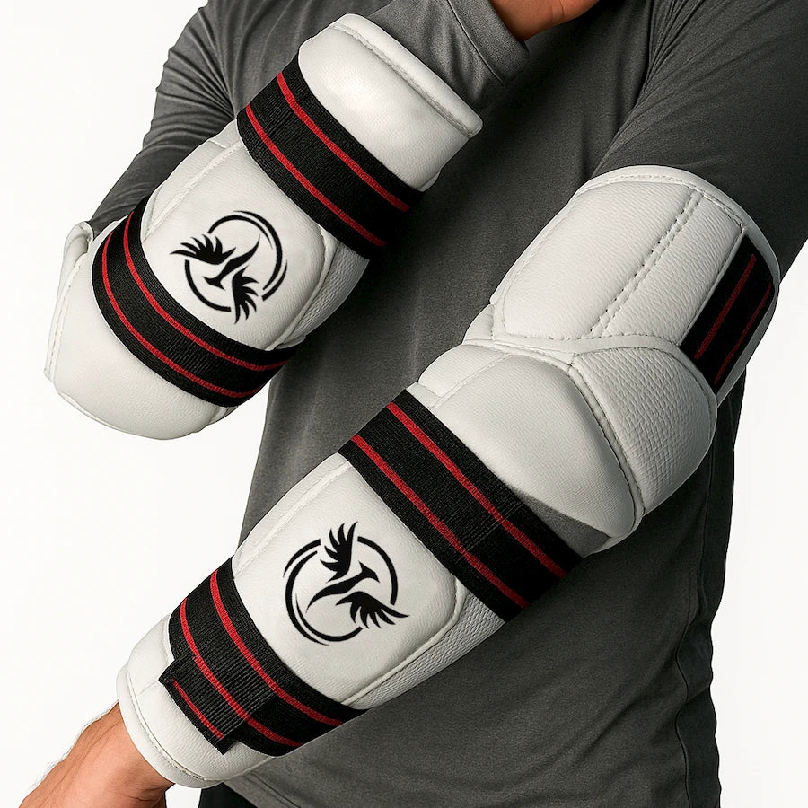 White elbow pads with black and red accents on a person wearing a gray long-sleeve shirt.