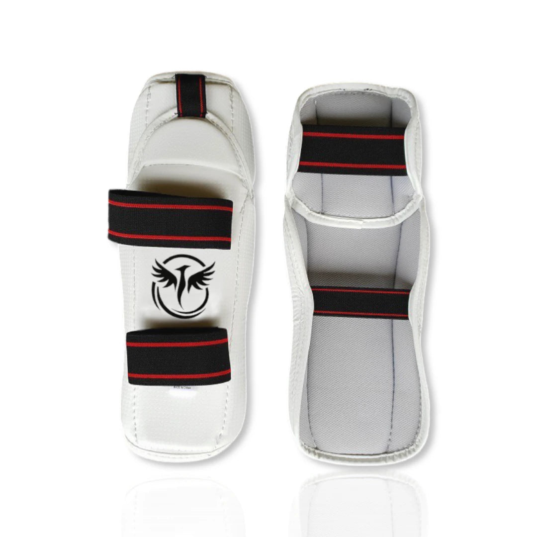 White martial arts shin guards with black and red accents on a white background