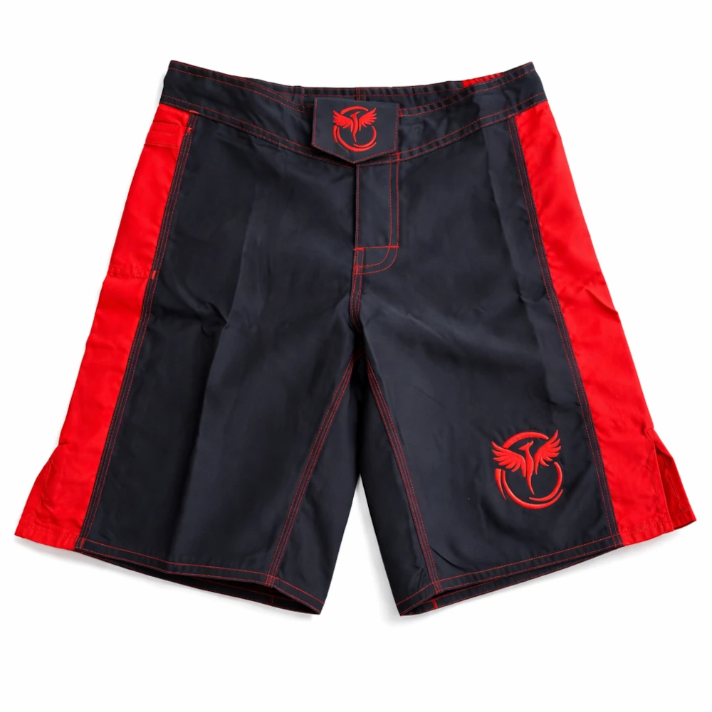 Black and red MMA shorts with a logo on a white background