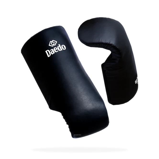 Black taekwondo arm guards with 'Daedo' branding on a white background