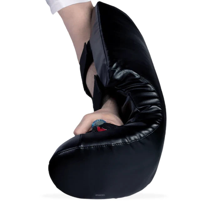 Black arm guard worn by a taekwondo practitioner on a white background