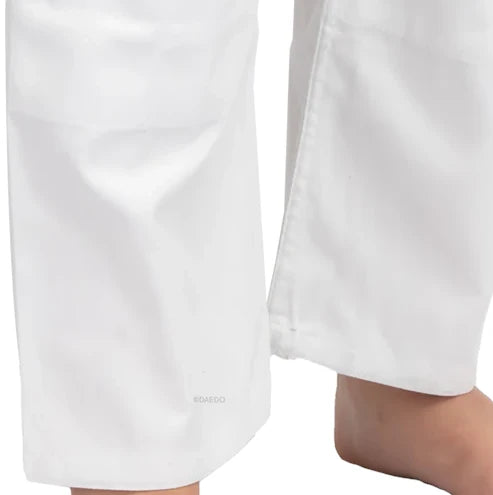 Close-up of white pants with a brand logo on a white background