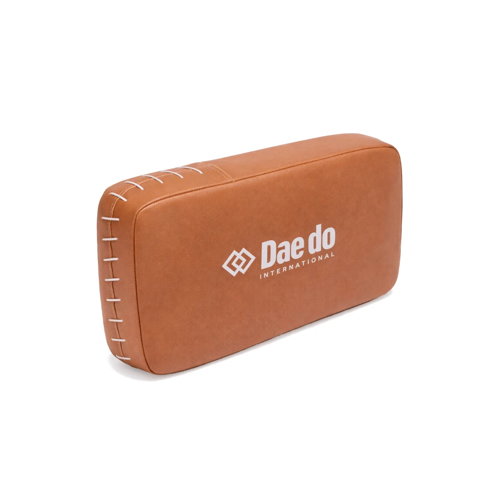 Brown rectangular kick shield with 'Dae do International' logo on a white background