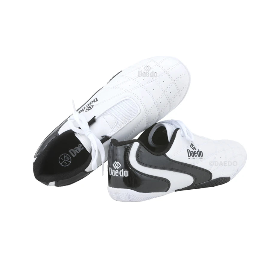 Pair of white and black shoes with 'Daedo' branding on a white background