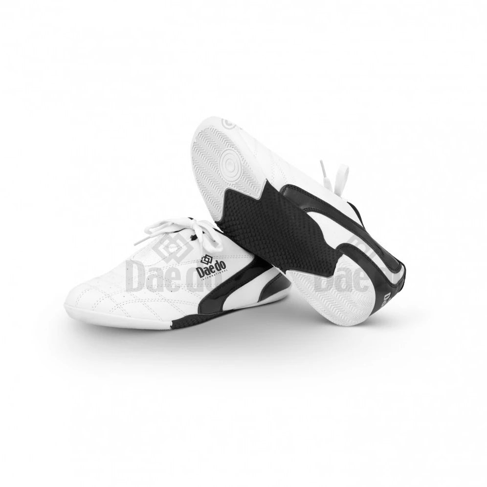 Pair of white and black shoes with 'Daedo' branding on a white background