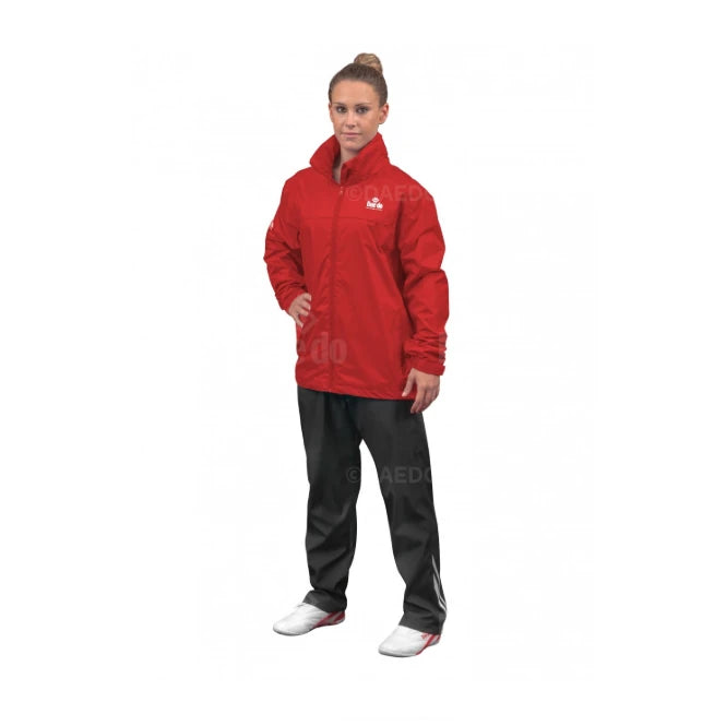 Woman wearing a red jacket and black pants on a white background