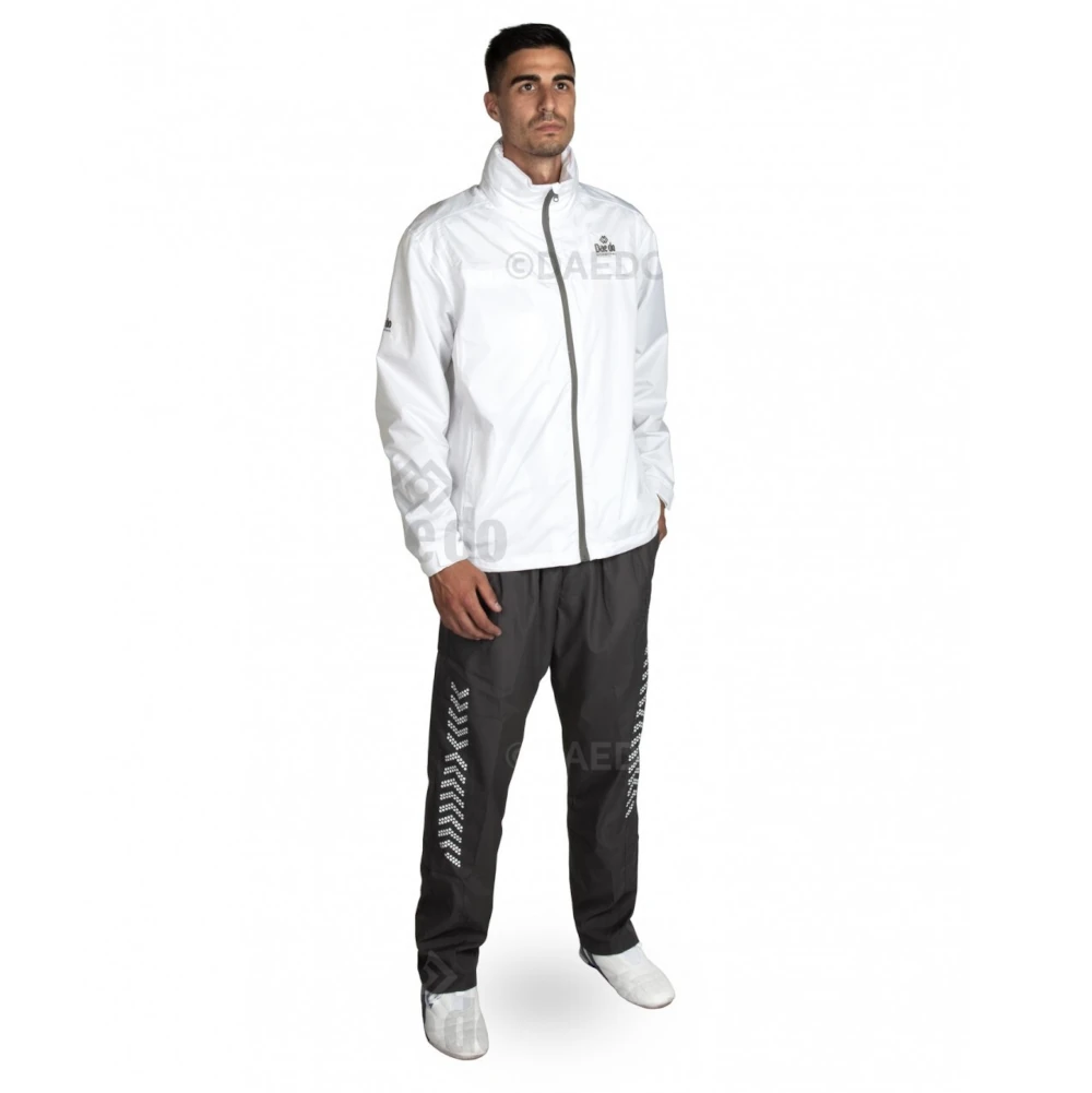 Man wearing a white tracksuit with visible branding on a white background