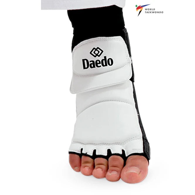 White taekwondo foot guard with black accents and Daedo branding on a white background.