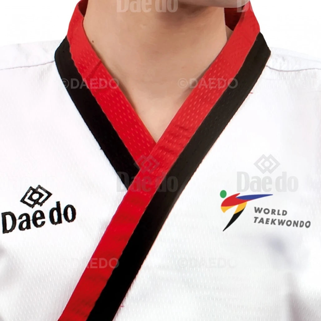White martial arts uniform with red and black belt featuring Daedo and World Taekwondo logos.