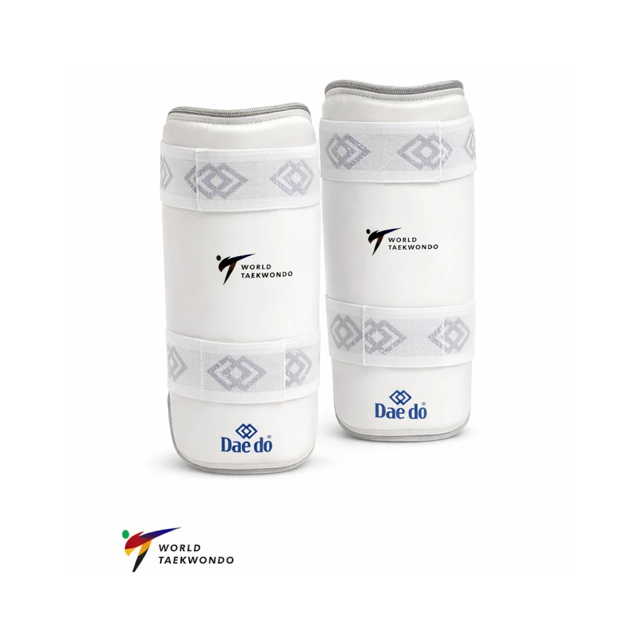 Pair of white shin guards with 'Dae do' and 'World Taekwondo' logos on a white background