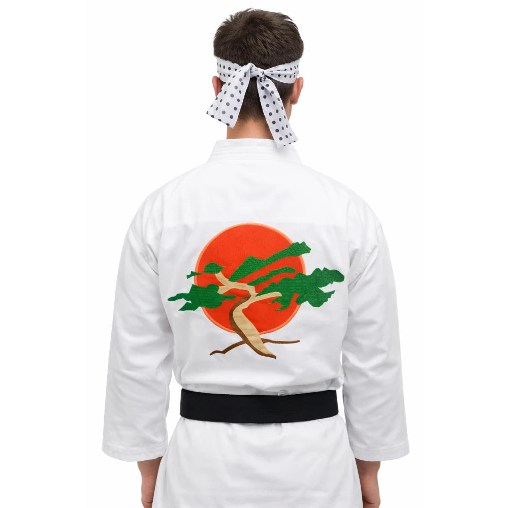 Person wearing a white martial arts uniform with a design on the back against a white background