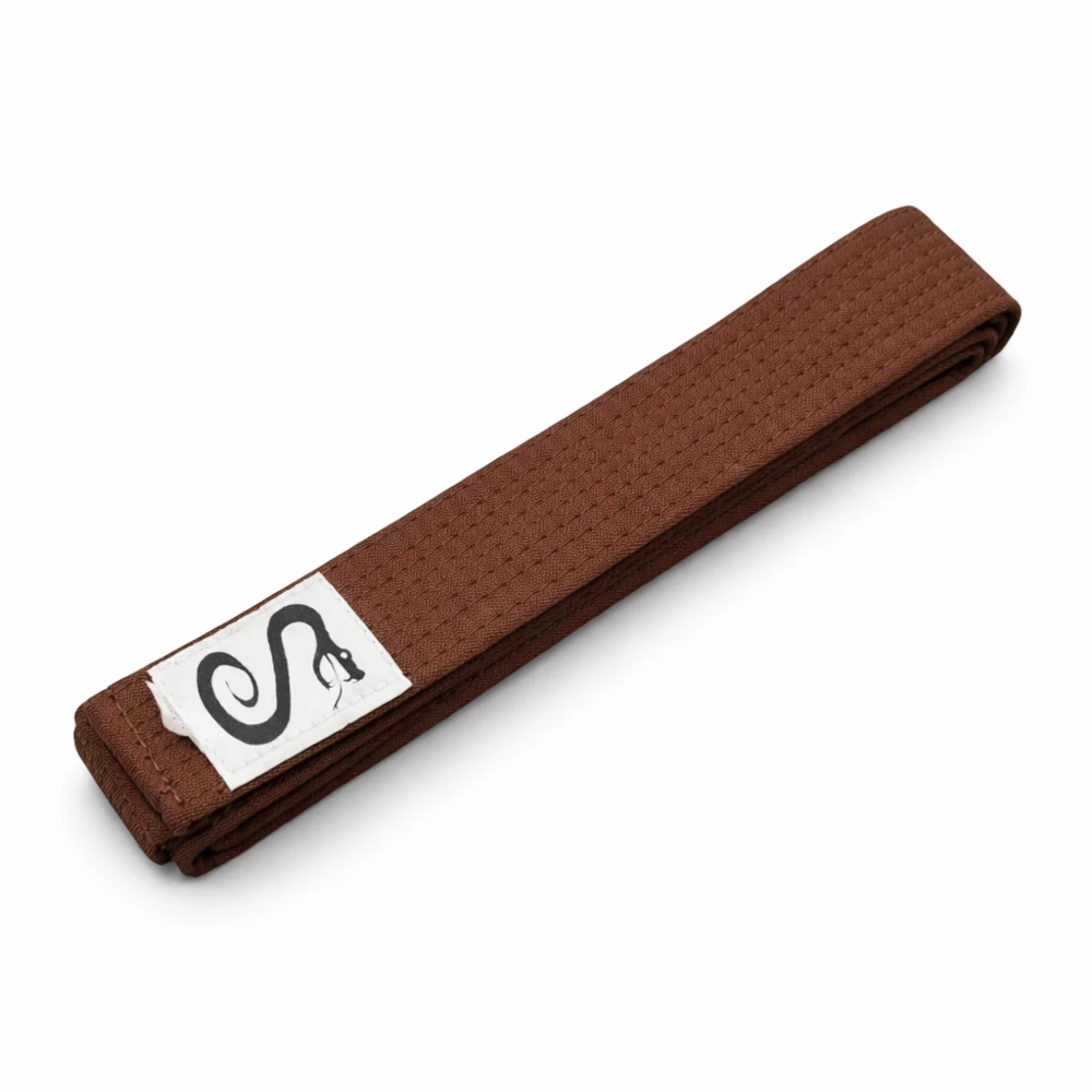 Brown belt with a white patch featuring a black snake design on a white background