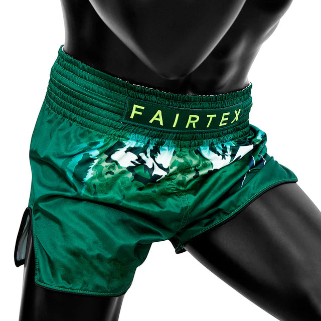 Green Muay Thai shorts with Fairtex branding on a mannequin against a white background