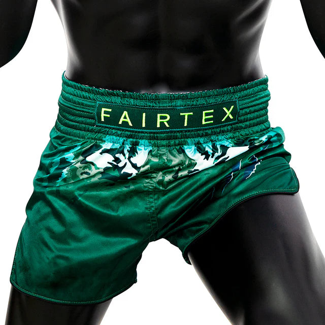 Green Muay Thai shorts with Fairtex branding on a white background