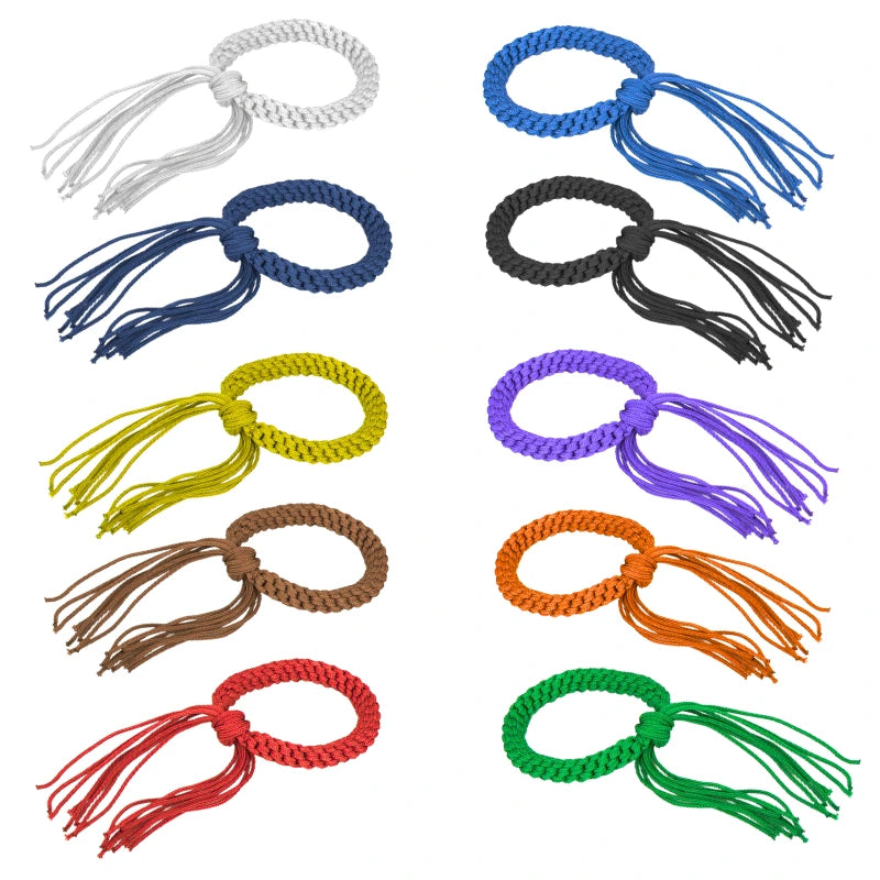 Set of colorful braided bracelets with tassels on a white background
