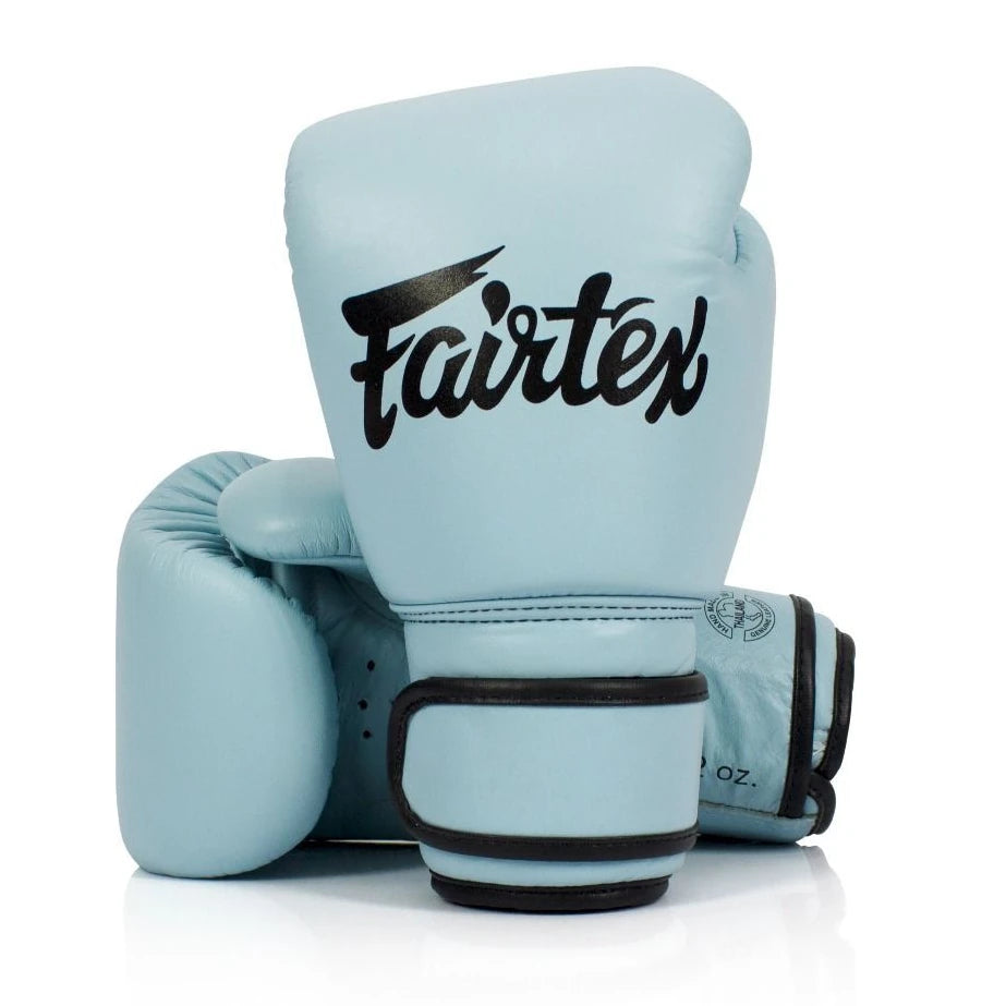 Light blue boxing gloves with black Fairtex logo on a white background