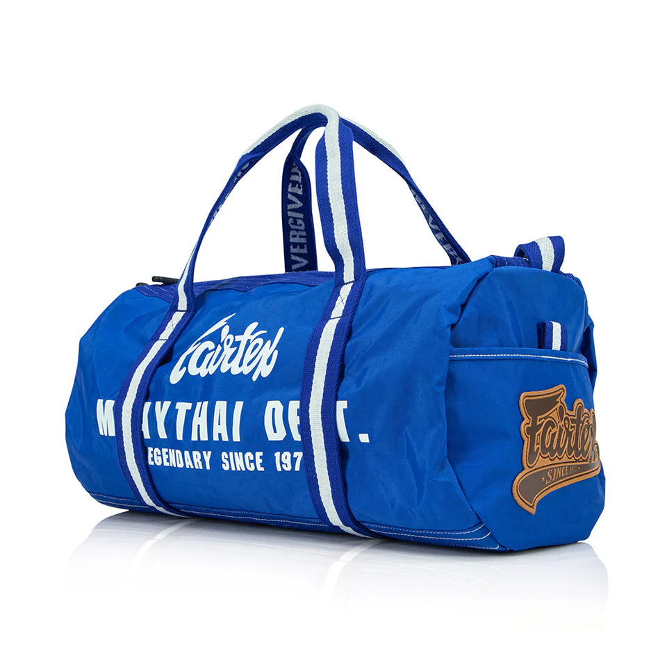 Blue duffel bag with white text and branding on a white background