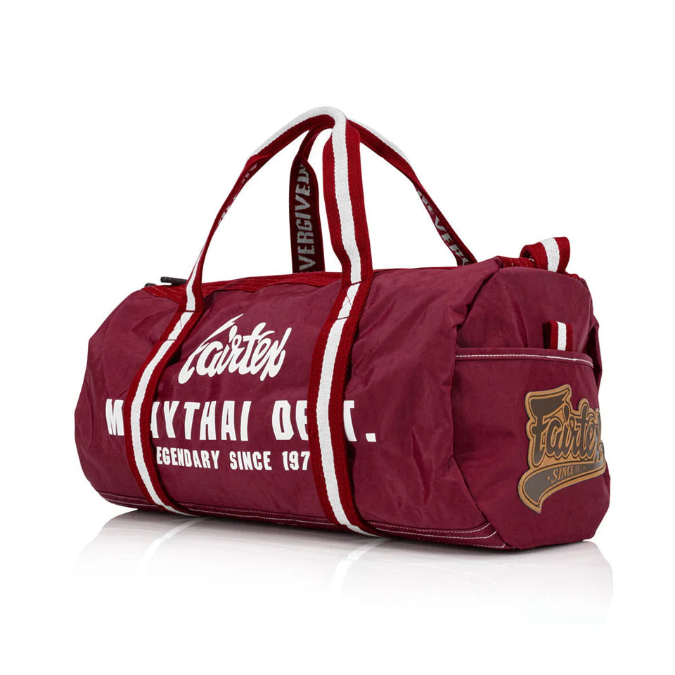 Red duffel bag with white text and branding on a white background