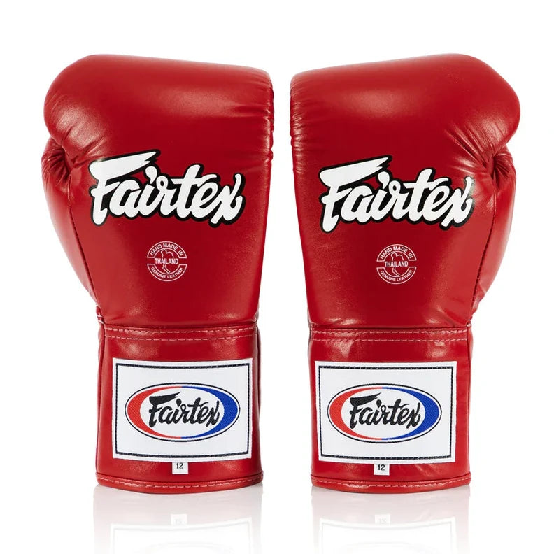 Pair of red Fairtex boxing gloves on a white background