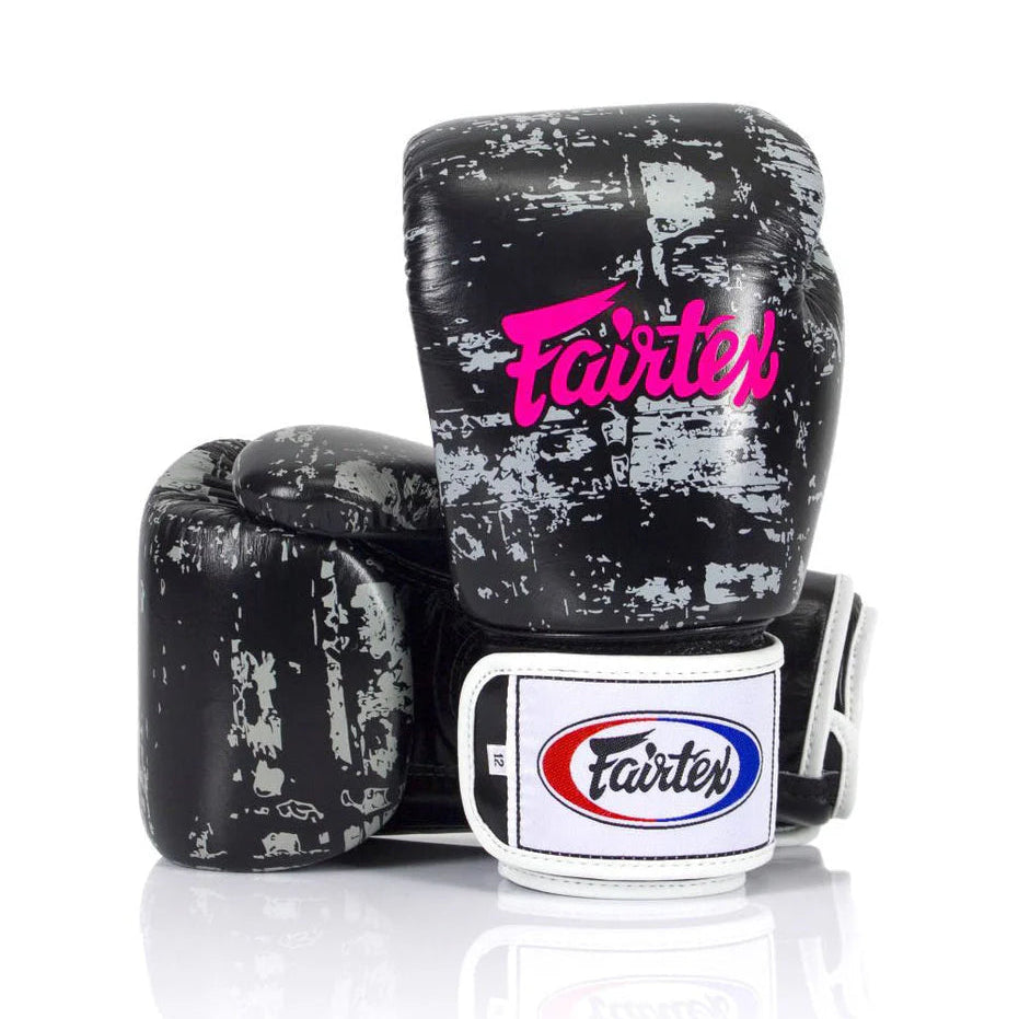 Black and gray boxing gloves with Fairtex logo on a white background