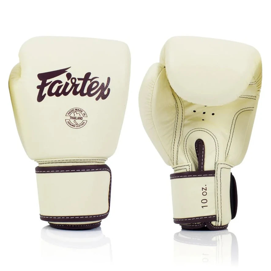 Pair of cream boxing gloves with Fairtex branding on a white background