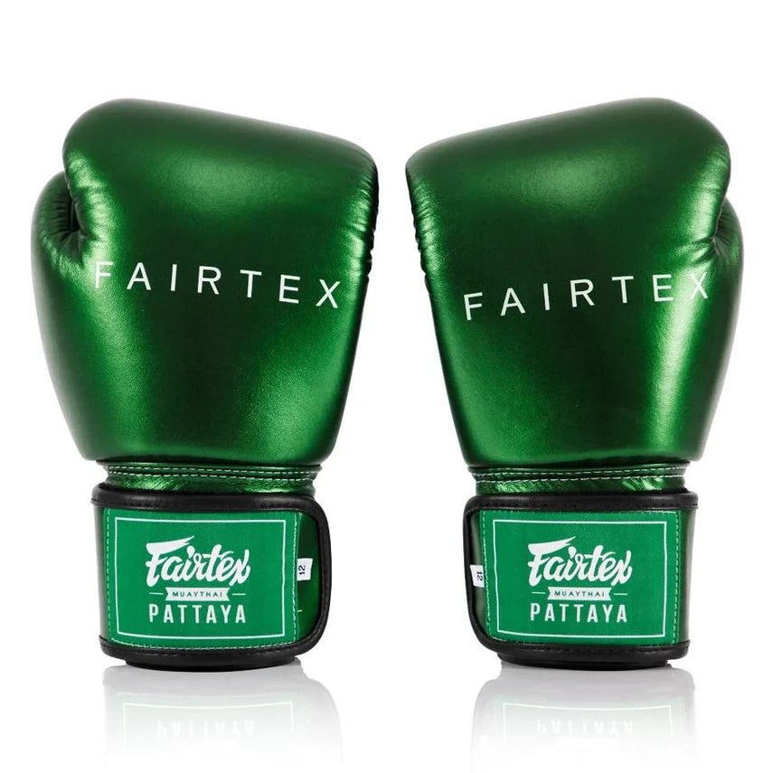 Pair of green Fairtex boxing gloves on a white background