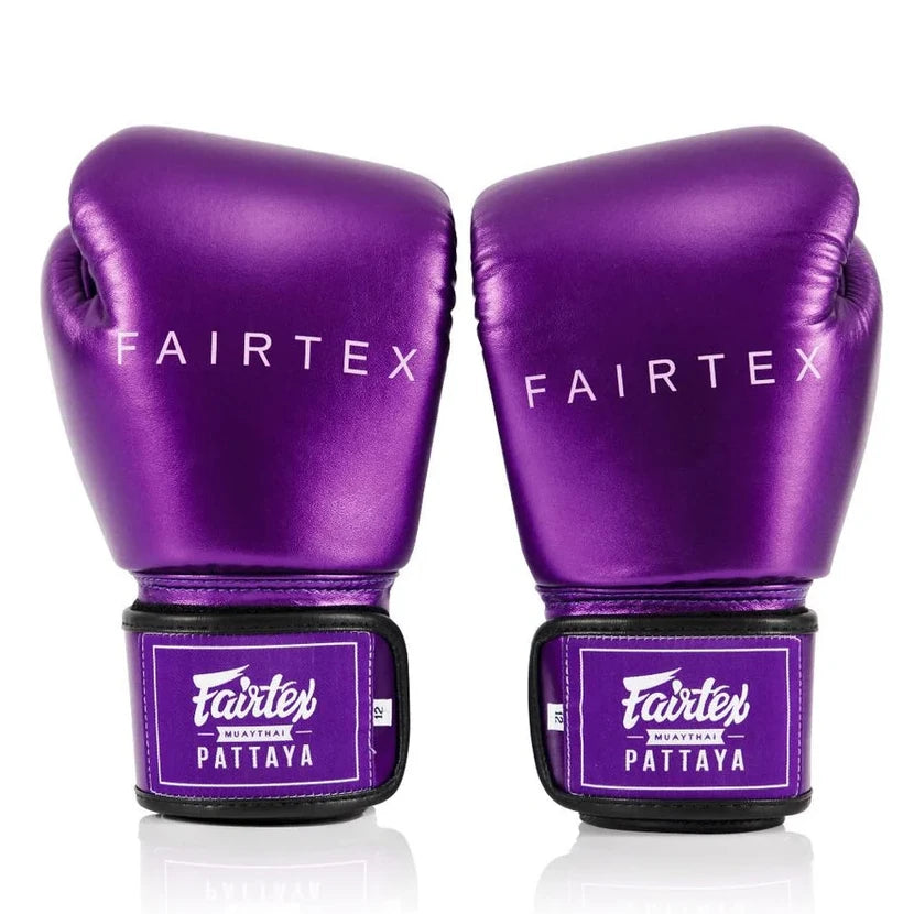 Purple Fairtex boxing gloves on a white background
