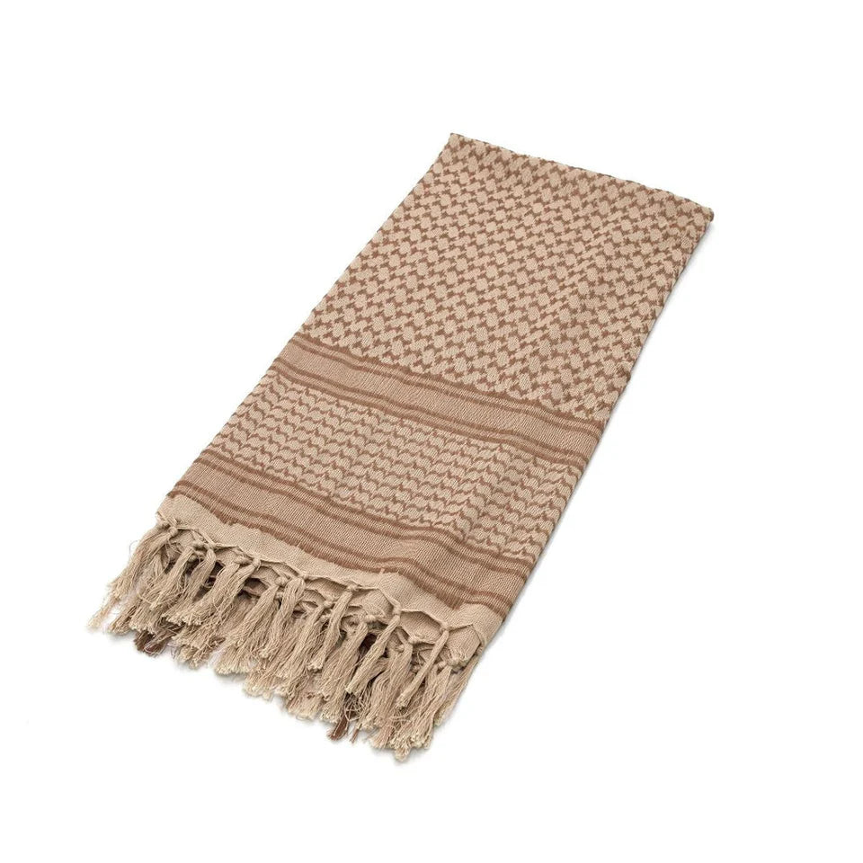 Beige woven blanket with fringes on a white background