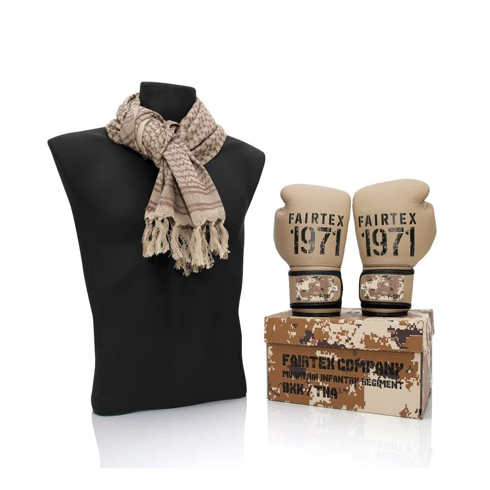 Camouflage scarf and boxing gloves with 'Fairtex 1971' branding on a black mannequin and box.