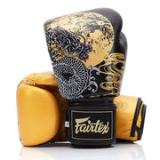 Pair of boxing gloves with dragon design and Fairtex branding on a white background