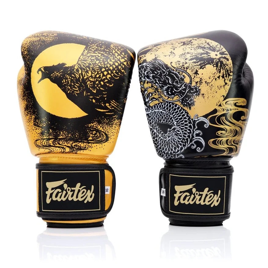 Pair of Fairtex boxing gloves with dragon and moon design on a white background