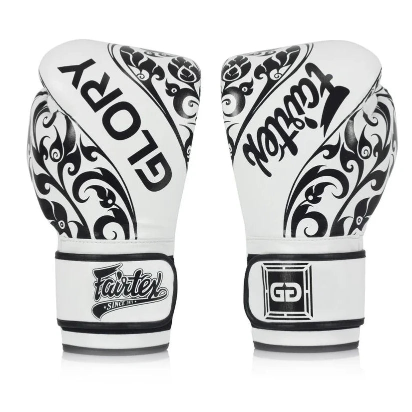 Pair of white boxing gloves with black patterns and Fairtex branding on a white background