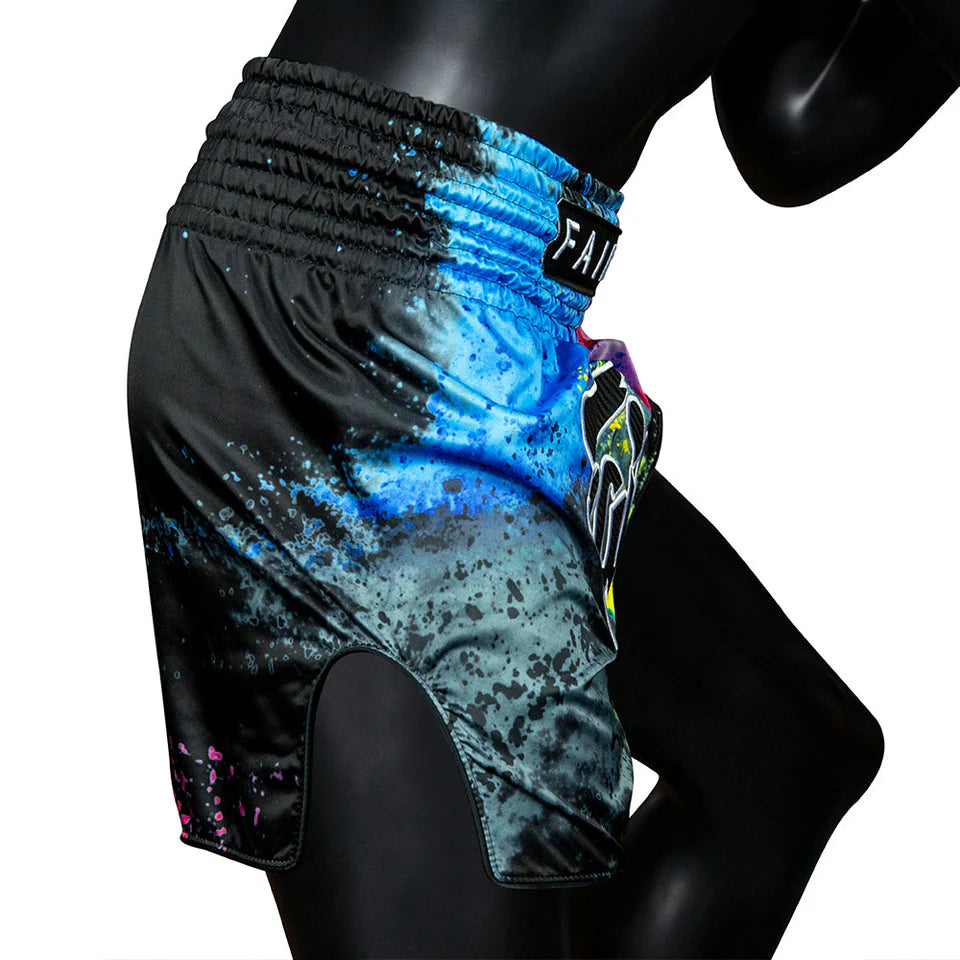 Colorful athletic Muay Thai shorts with a brand logo on a mannequin against a white background