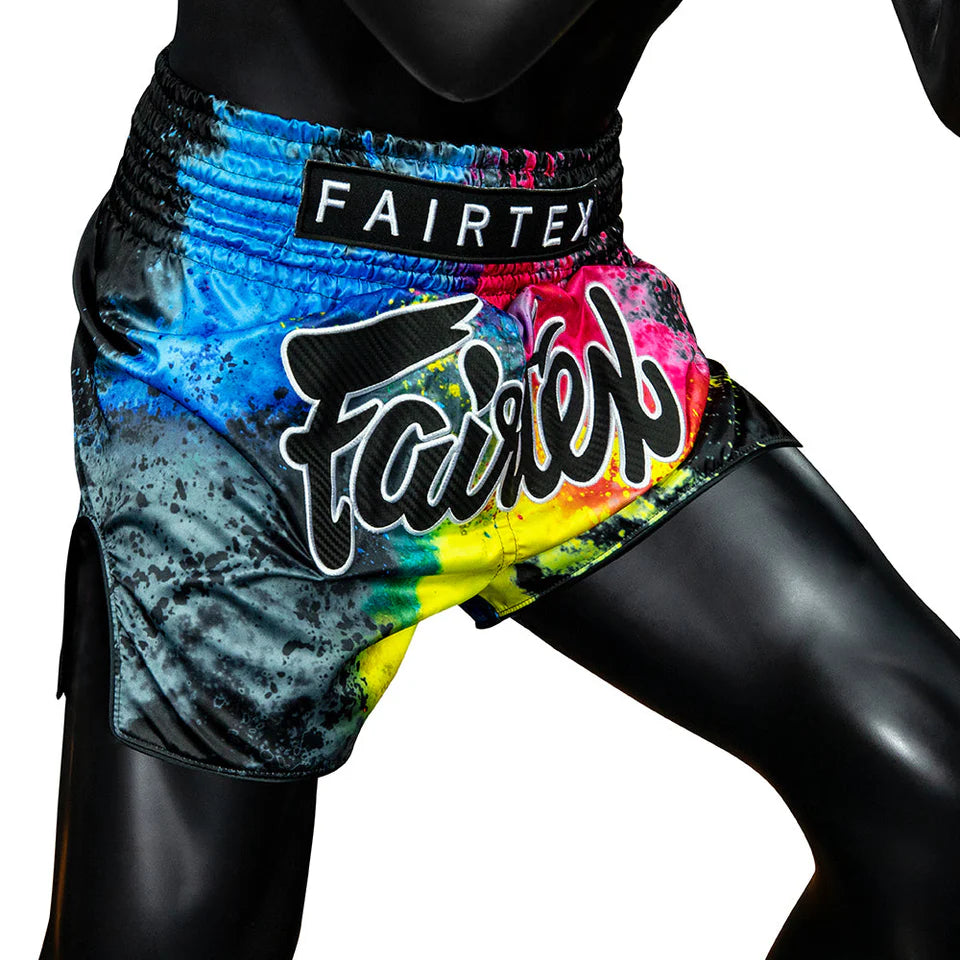 Colorful Muay Thai shorts with Fairtex branding on a black background