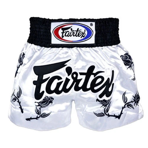 White Muay Thai shorts with black text and Fairtex logo on a white background