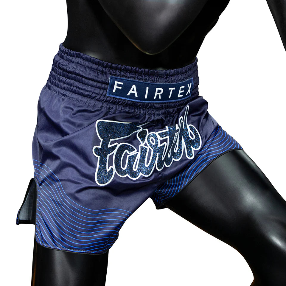 Blue Fairtex boxing shorts on a mannequin against a white background