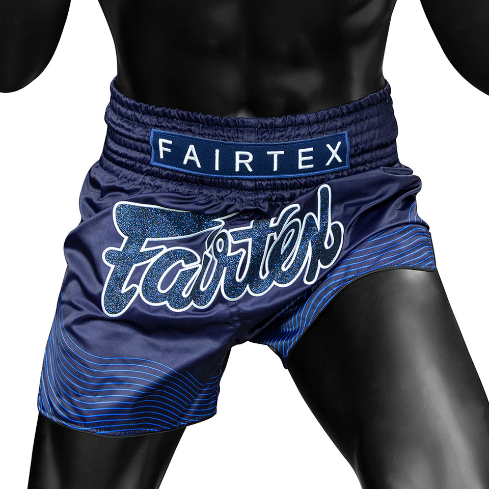 Blue Fairtex boxing shorts on a black background