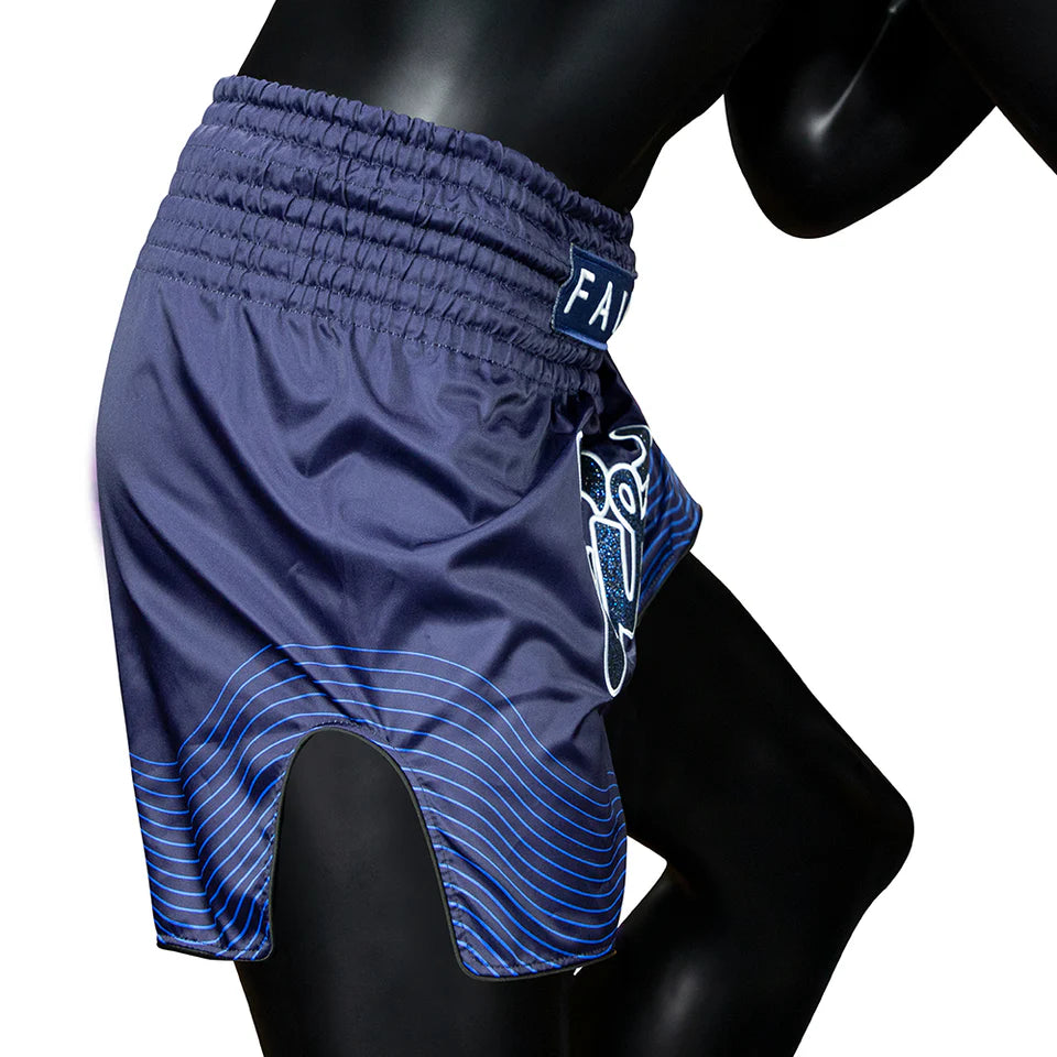 Blue athletic Muay Thai shorts with a brand logo on a mannequin against a white background
