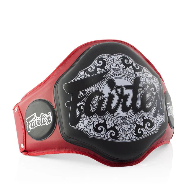 Red and black belly pad with 'Fairtex' branding on a white background