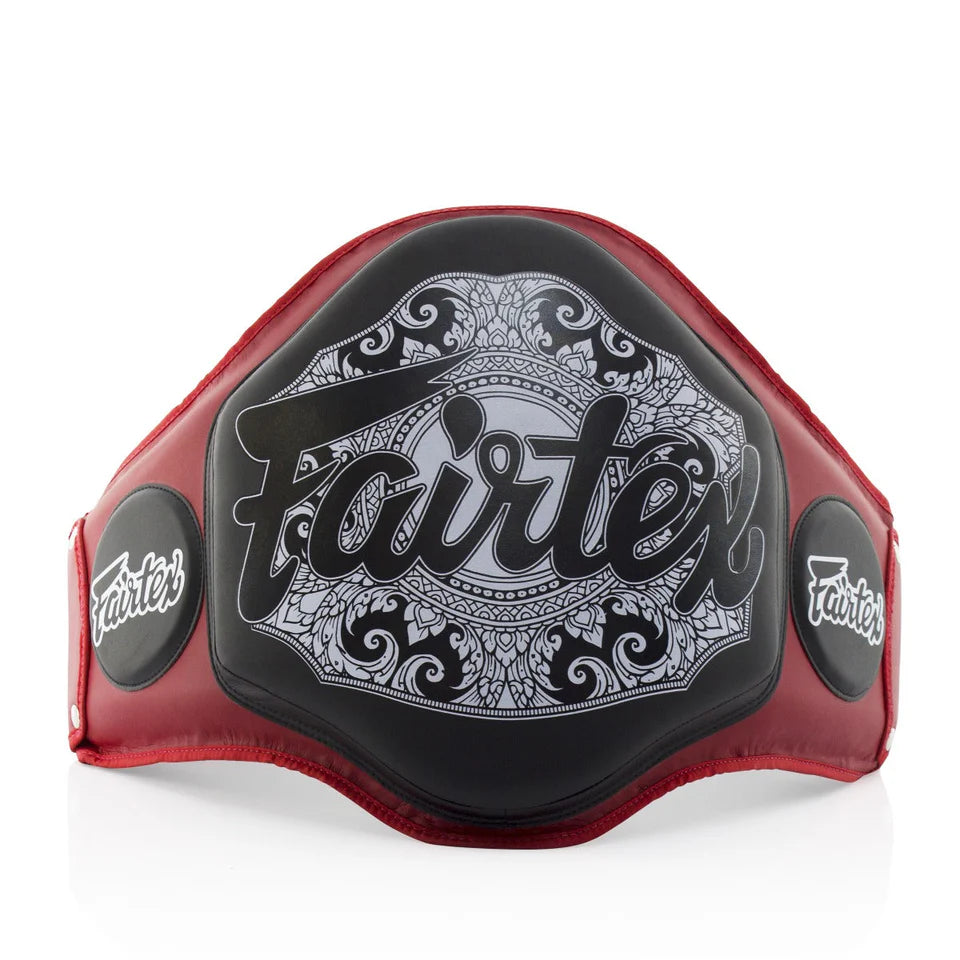 Red and black belly pad with 'Fairtex' branding on a white background