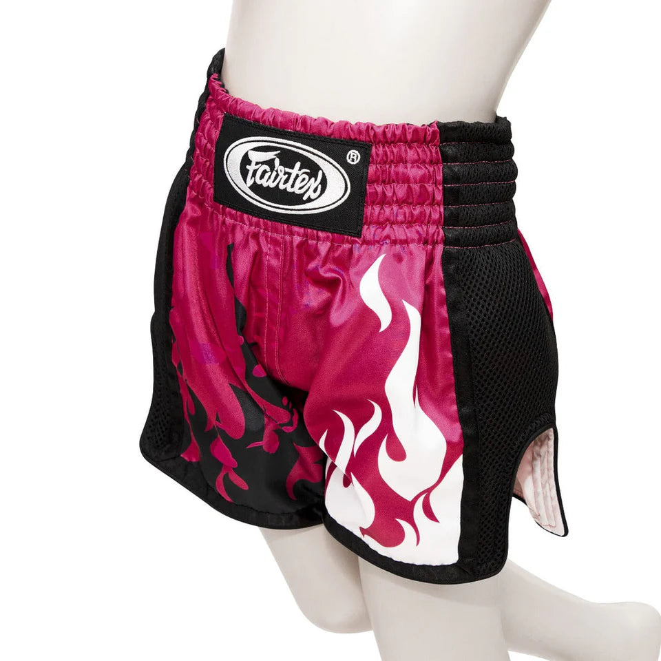 Pink and black boxing shorts with flame design on a mannequin against a white background