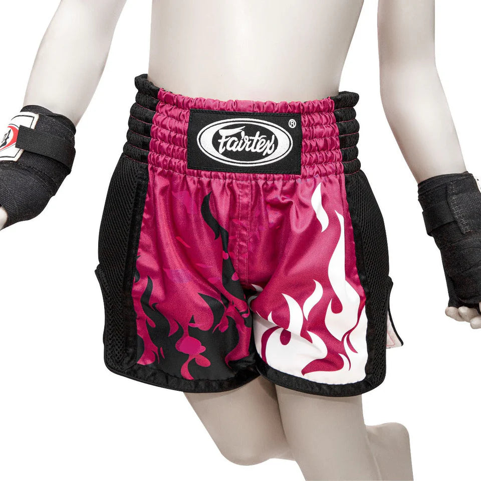 Pink and black flame-patterned boxing shorts with Fairtex logo on a mannequin.