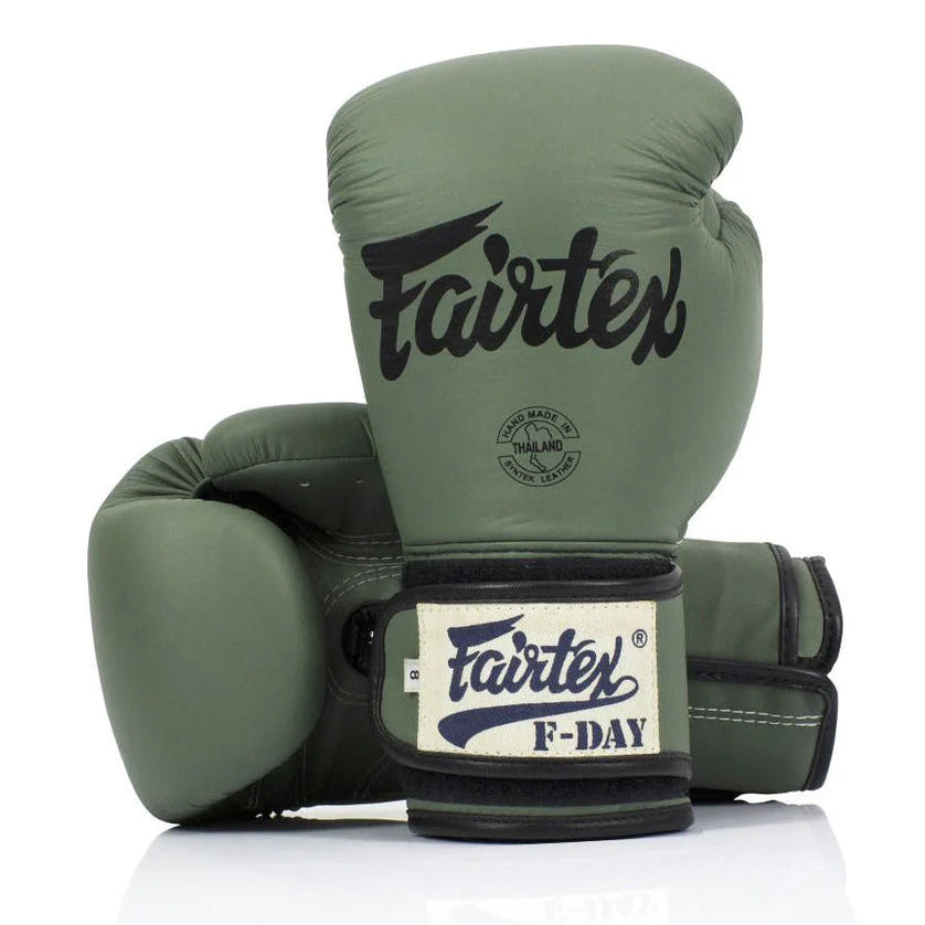 Green boxing gloves with Fairtex branding on a white background