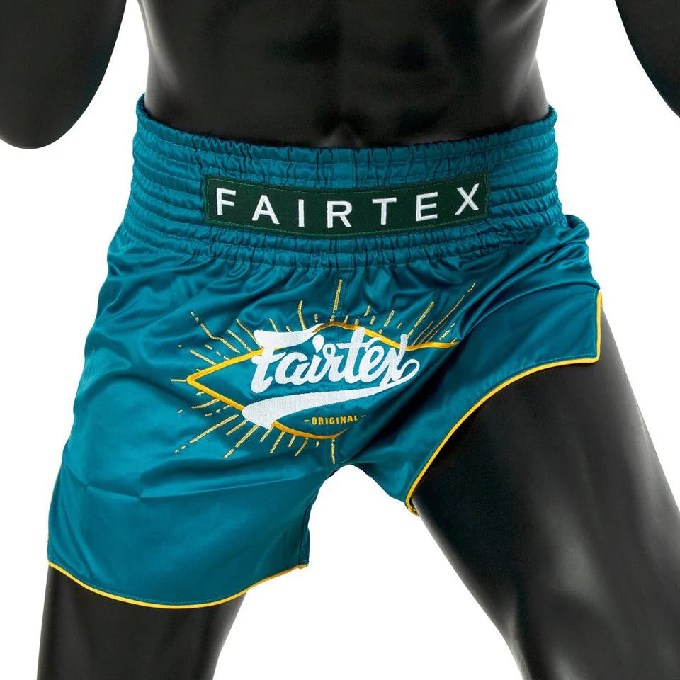 Teal Fairtex boxing shorts with brand logo on a white background