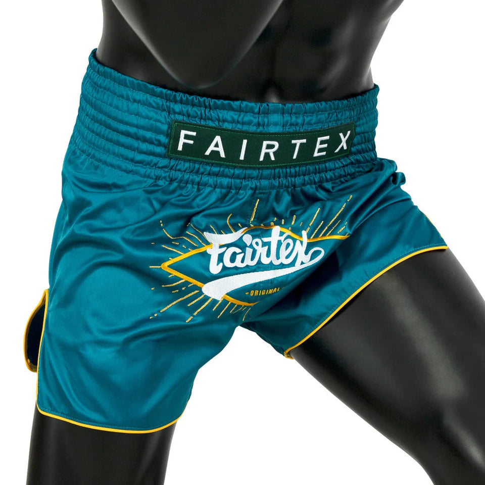 Teal Fairtex Muay Thai shorts on a mannequin with a white background