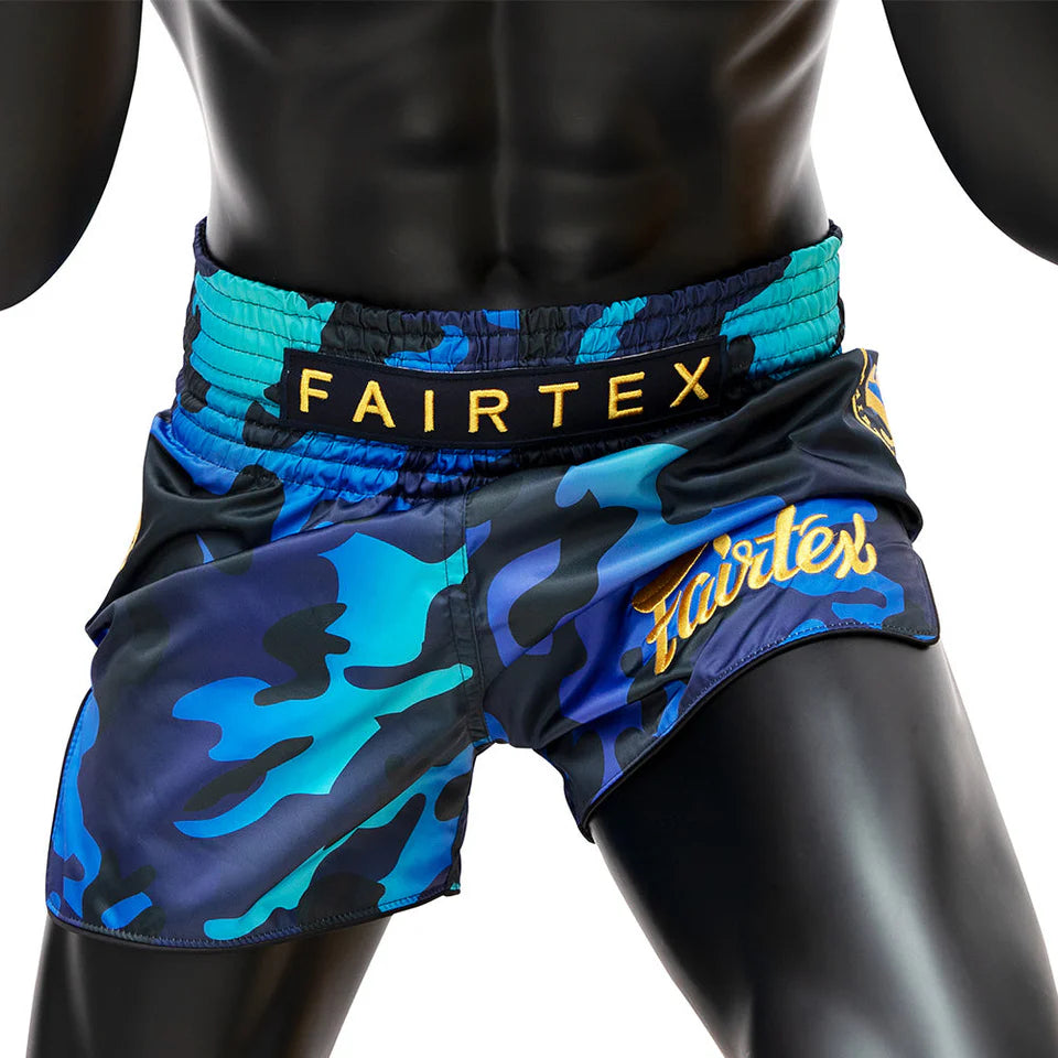 Blue camouflage Muay Thai shorts with Fairtex branding on a white background