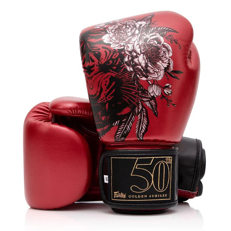 Red boxing gloves with floral design and '50' logo on a white background