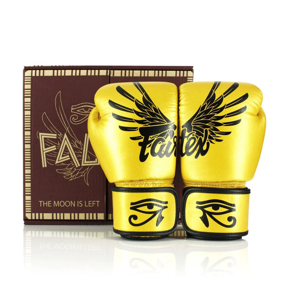 Yellow boxing gloves with black designs and a brown box in the background