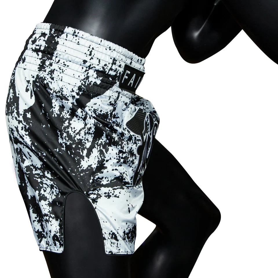 Black and white patterned Muay Thai shorts on a mannequin against a white background