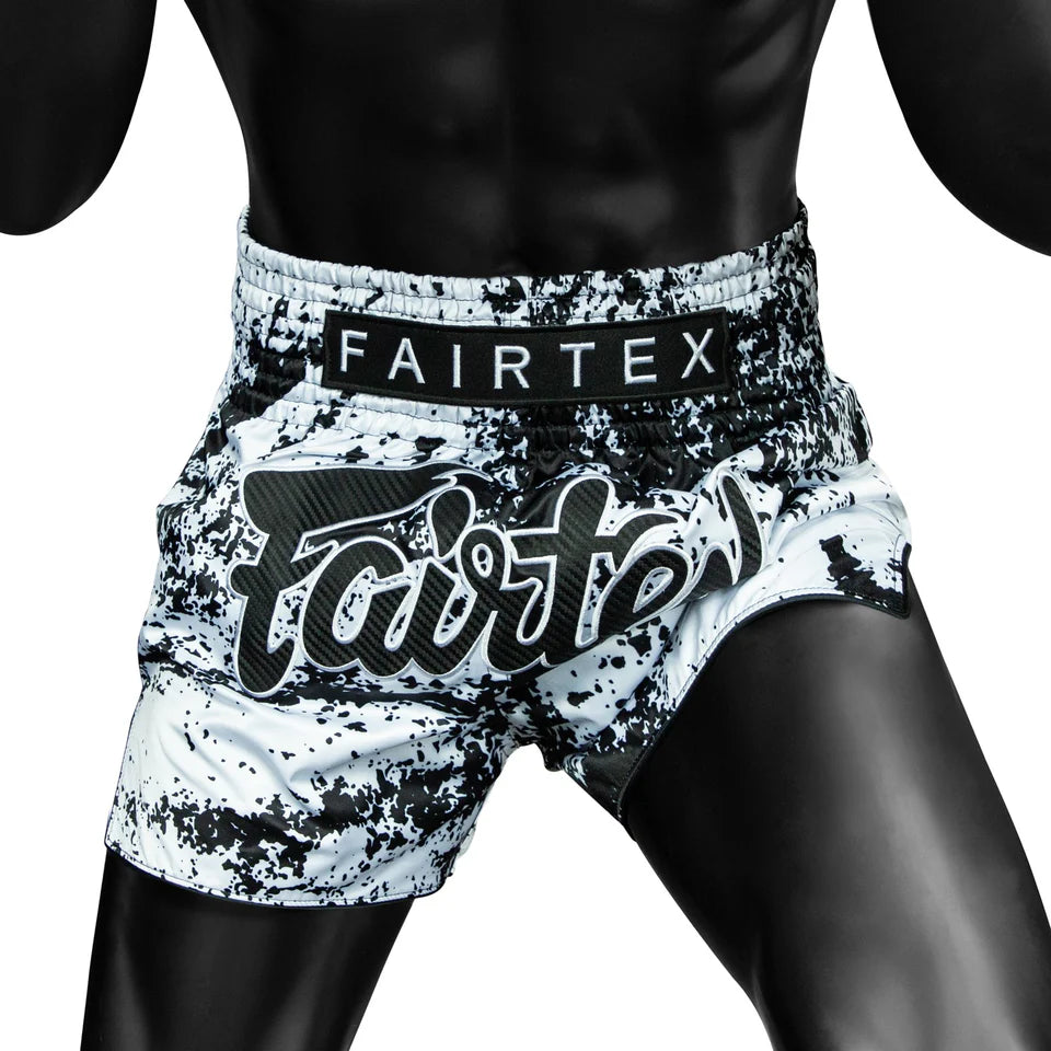 Black and white patterned Fairtex shorts on a person against a white background